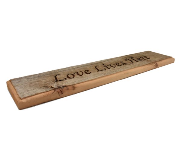 Barnwood door topper sign that reads, "Love Lives Here".