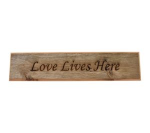 Barnwood door topper sign that reads, "Love Lives Here".