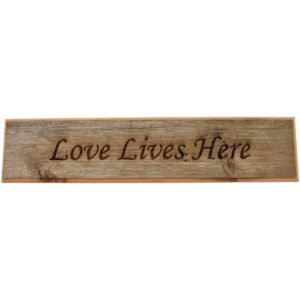 Barnwood door topper sign that reads, "Love Lives Here".