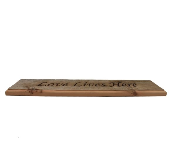 Barnwood door topper sign that reads, "Love Lives Here".