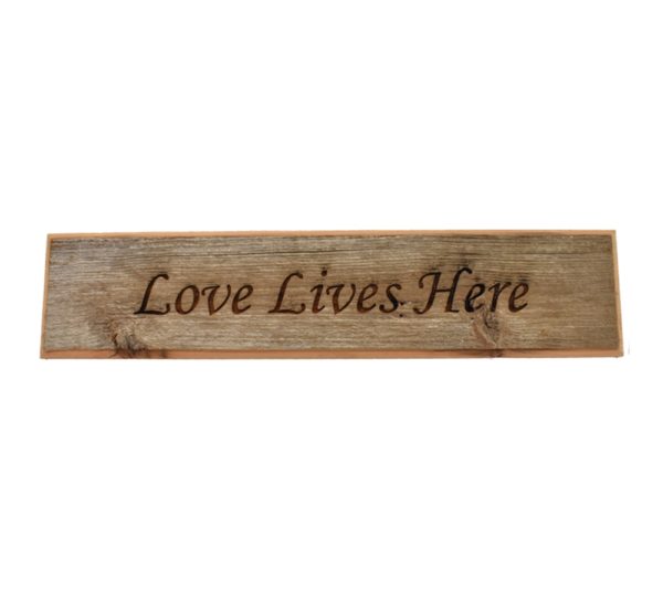 Barnwood door topper sign that reads, "Love Lives Here".