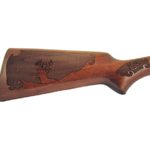 Gun stock engraving with checkering and deer antlers and a deer head.