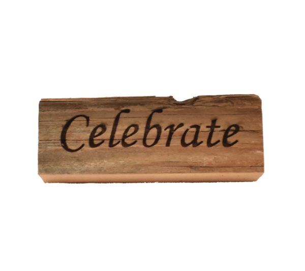 Reclaimed barn wood block sign that reads, "Celebrate".