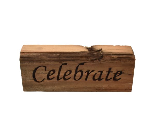 Reclaimed barn wood block sign that reads, "Celebrate".