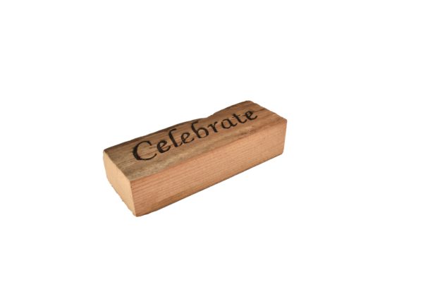 Reclaimed barn wood block sign that reads, "Celebrate".