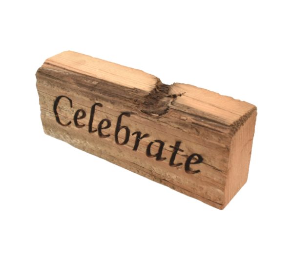 Reclaimed barn wood block sign that reads, "Celebrate".