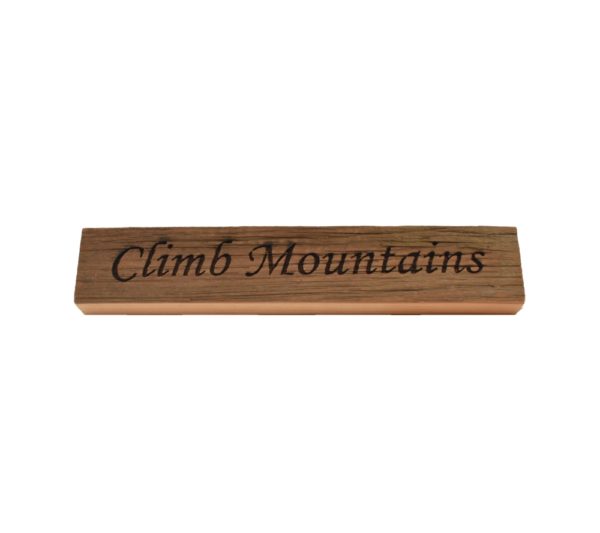 Reclaimed barn wood block sign that reads, "Climb Mountains".