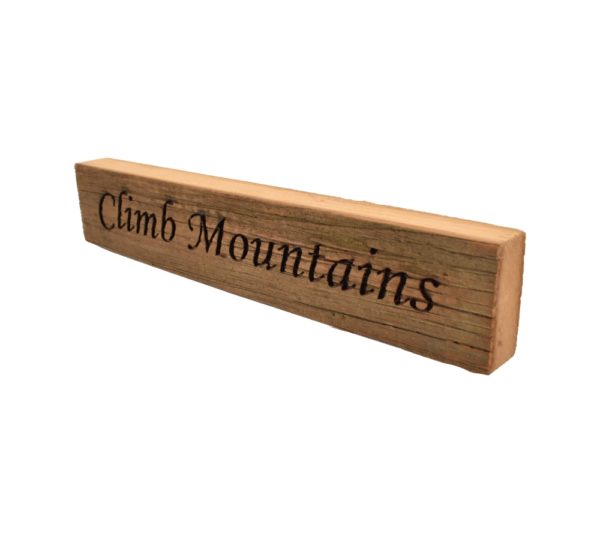 Reclaimed barn wood block sign that reads, "Climb Mountains".