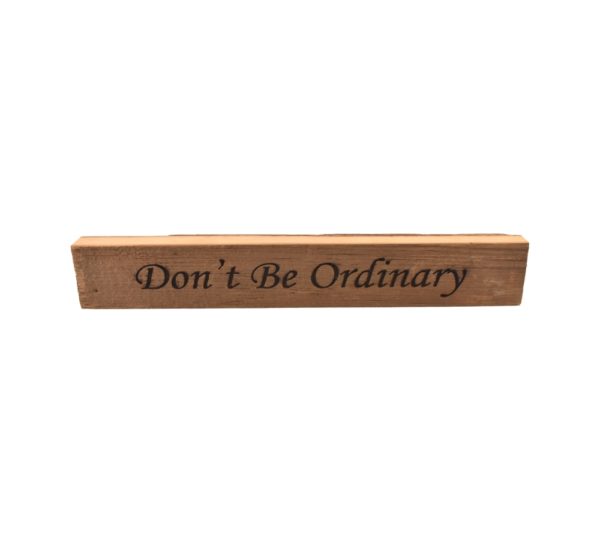 Reclaimed barn wood block sign that reads, "Don't Be Ordinary".