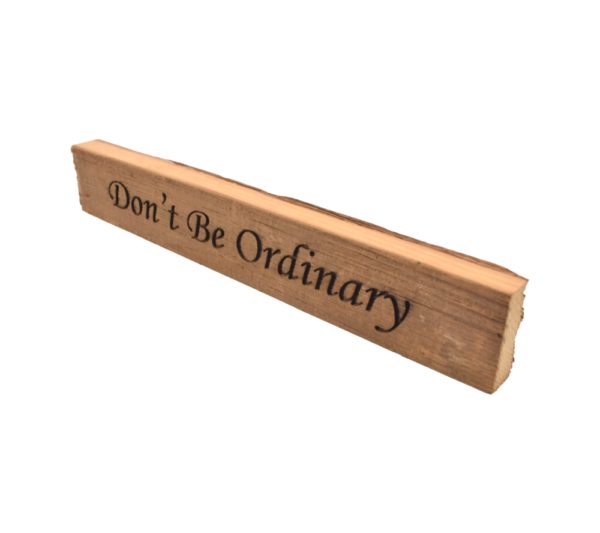 Reclaimed barn wood block sign that reads, "Don't Be Ordinary".