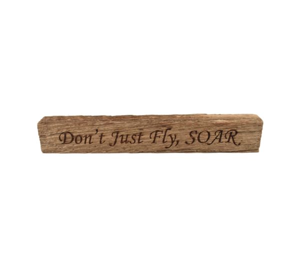 Reclaimed barn wood block sign that reads, "Don't Just Fly, SOAR".