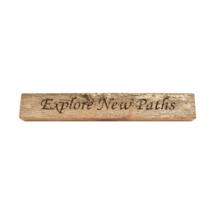 Reclaimed barn wood block sign that reads, "Explore New Paths".