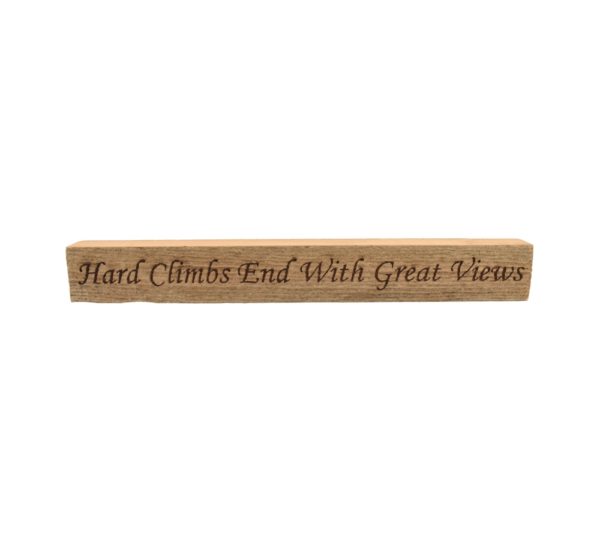 Reclaimed barn wood block sign that reads, "Hard Climbs End With Great Views".