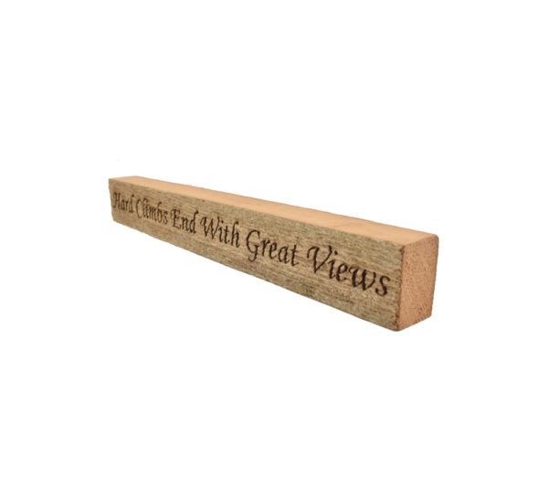 Reclaimed barn wood block sign that reads, "Hard Climbs End With Great Views".