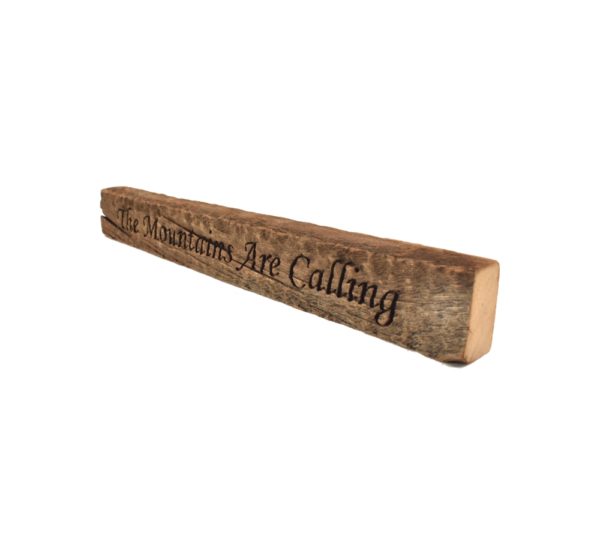 Reclaimed barn wood block sign that reads, "The Mountains Are Calling".