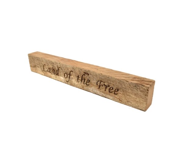 Reclaimed barn wood block sign that reads, "Land of the Free".