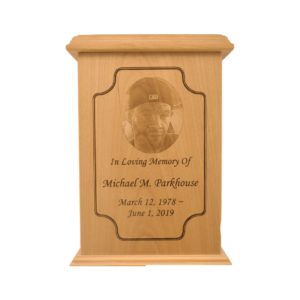 Tall rectangular urn with an engraved picture.