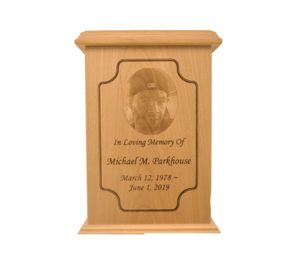 Tall rectangular urn with an engraved picture.