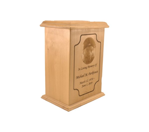Tall rectangular urn with an engraved picture.