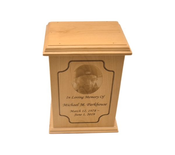 Tall rectangular urn with an engraved picture.