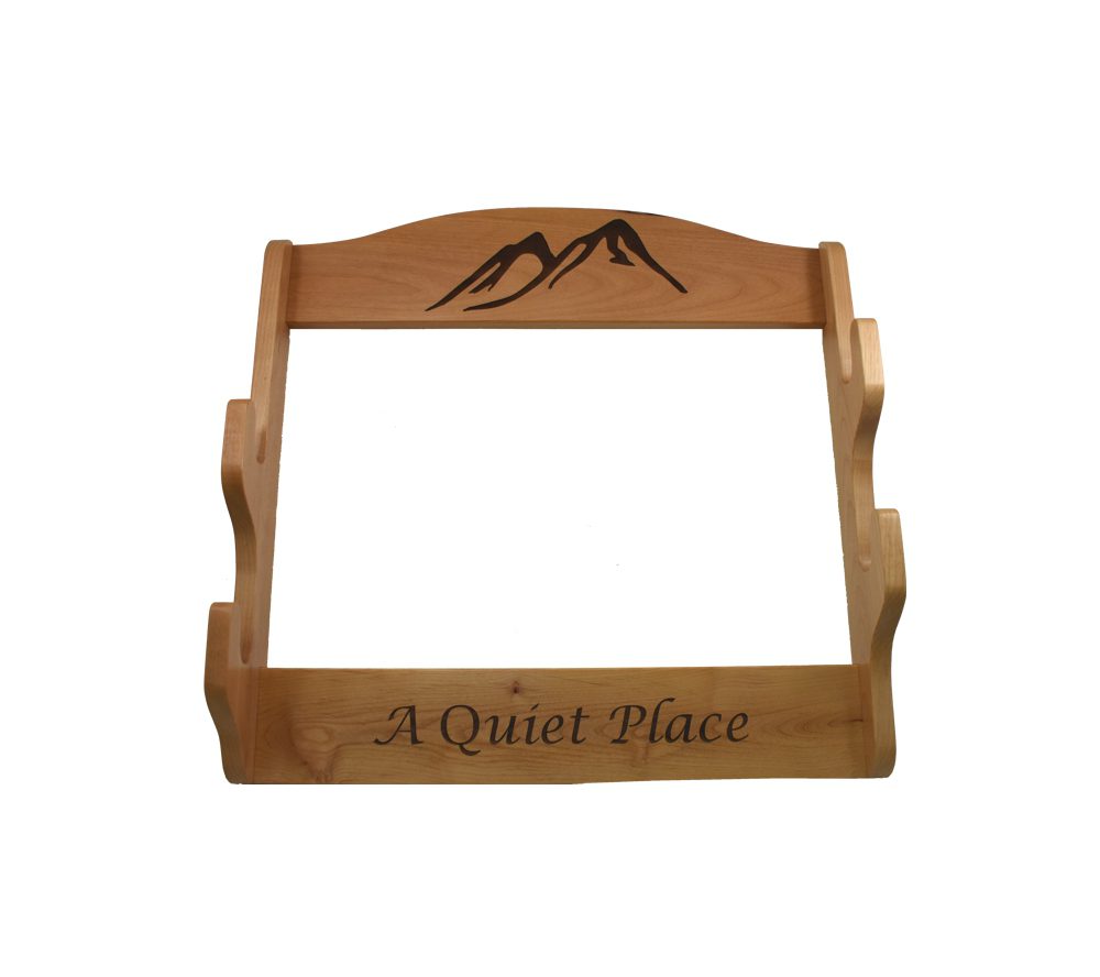 Detailed laser engraving of outdoor scene on personalized gun rack for hunters