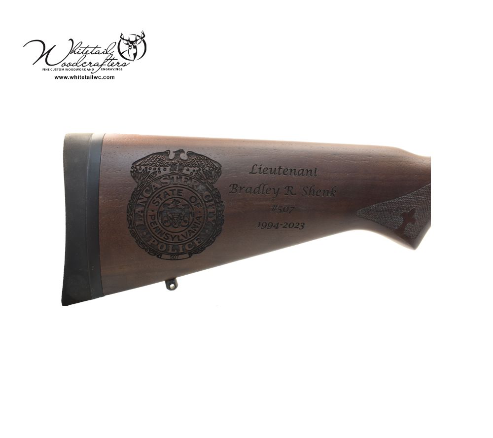 Engraved rifle stock with police badge and years of service for retirement ceremony. 